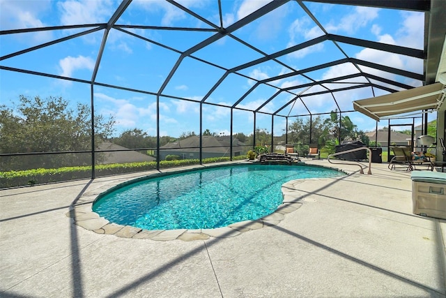 view of pool featuring glass enclosure and a patio