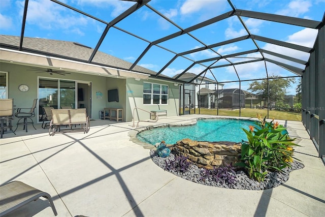 view of pool with a patio, ceiling fan, and a lanai