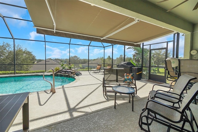 view of swimming pool with a lanai and a patio