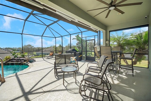 view of patio / terrace featuring ceiling fan and glass enclosure