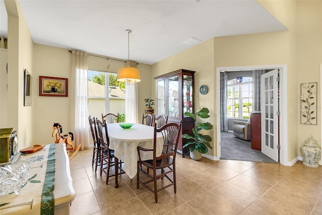 dining space with french doors and light tile patterned flooring