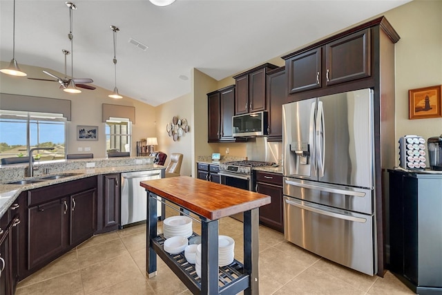 kitchen featuring light stone countertops, sink, ceiling fan, lofted ceiling, and appliances with stainless steel finishes