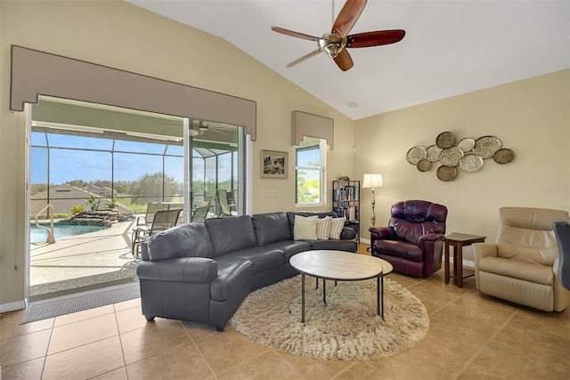 living room with ceiling fan, light tile patterned floors, and vaulted ceiling