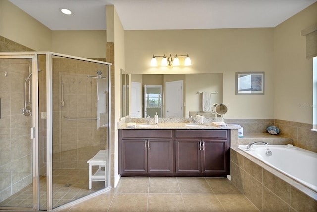 bathroom featuring tile patterned flooring, vanity, and separate shower and tub