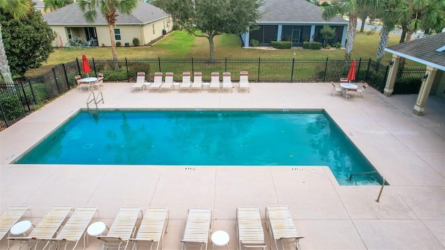 view of pool with a lawn and a patio area