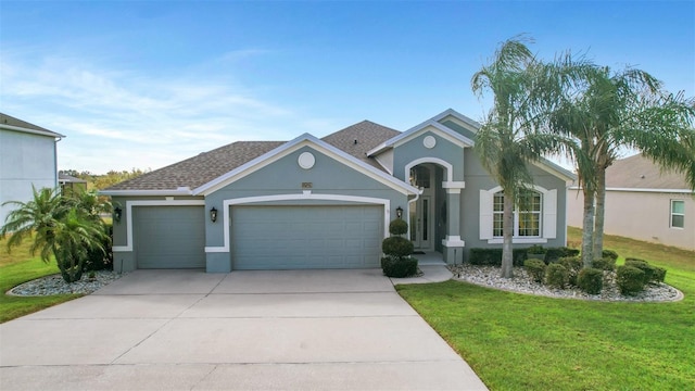 single story home with a garage and a front yard