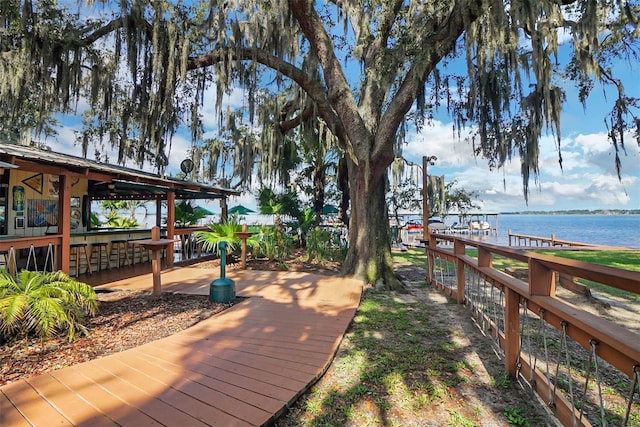 wooden deck with a bar and a water view