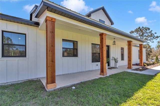 exterior space featuring board and batten siding and a yard