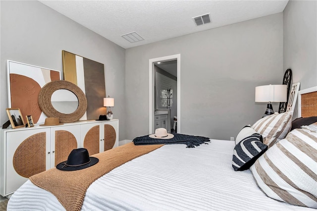 bedroom with visible vents and a textured ceiling