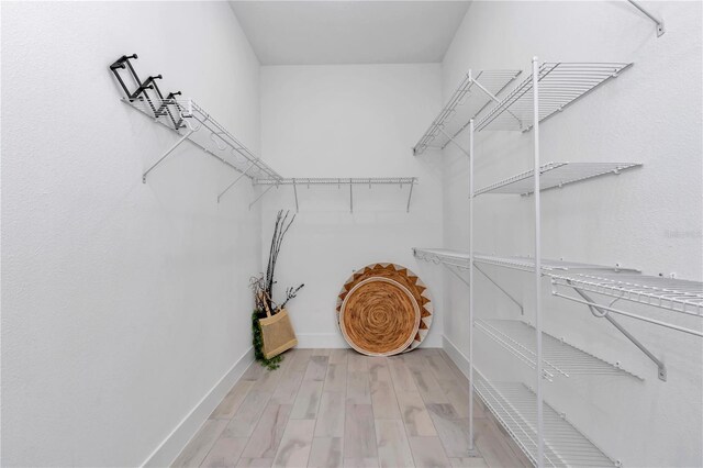 spacious closet with wood finished floors