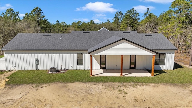 back of house featuring central AC, a shingled roof, board and batten siding, and a patio area