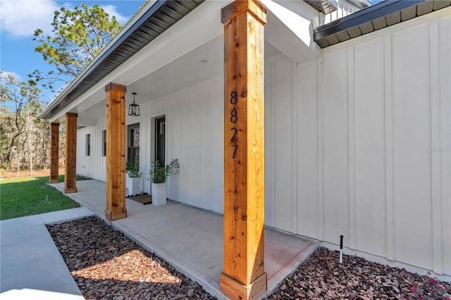 entrance to property featuring a porch and board and batten siding