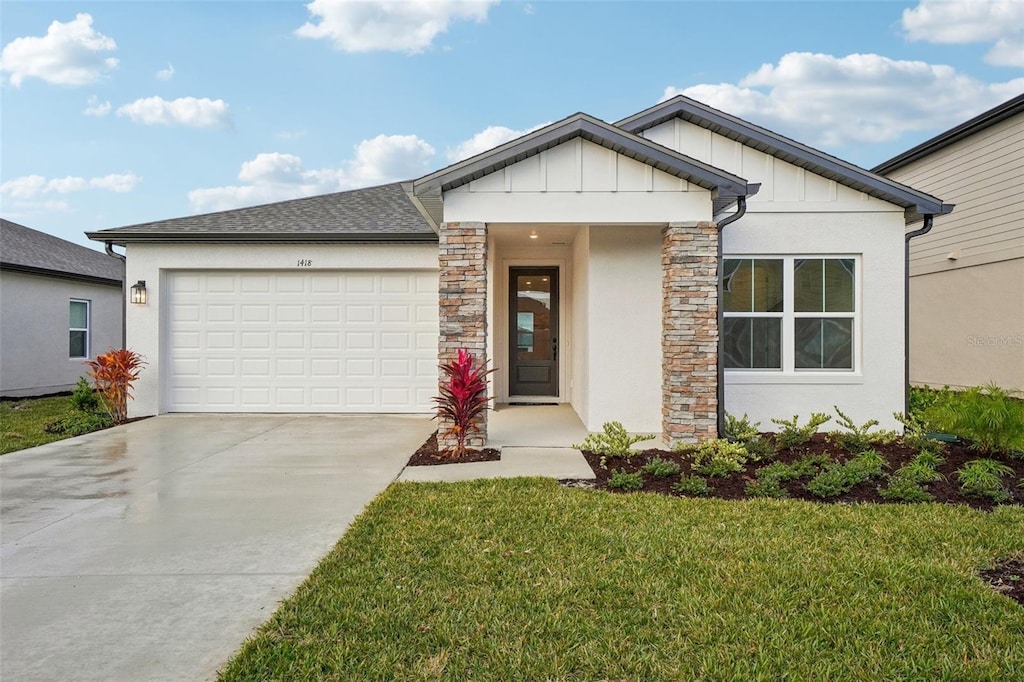 view of front facade with a front yard and a garage