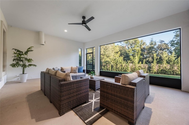 carpeted living room featuring ceiling fan