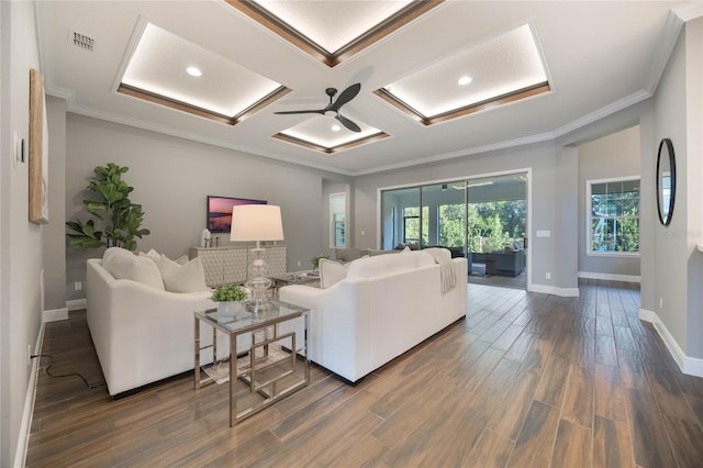 living room featuring ornamental molding, dark hardwood / wood-style flooring, ceiling fan, and coffered ceiling