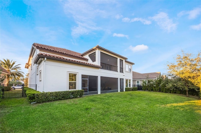 rear view of property with a sunroom and a yard