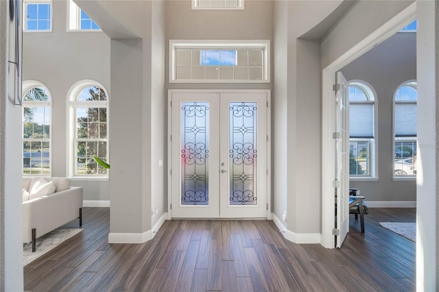 entrance foyer with french doors, dark hardwood / wood-style flooring, and a high ceiling