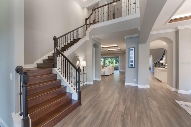 entryway featuring crown molding and hardwood / wood-style flooring