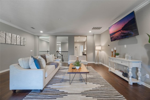 living room with dark wood-type flooring and ornamental molding