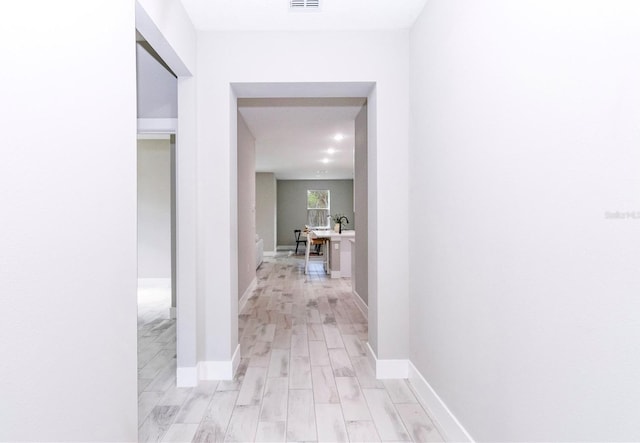 12220 SW 76th Ln, Dunnellon, FL 34432 - hallway featuring light wood-type flooring and baseboards