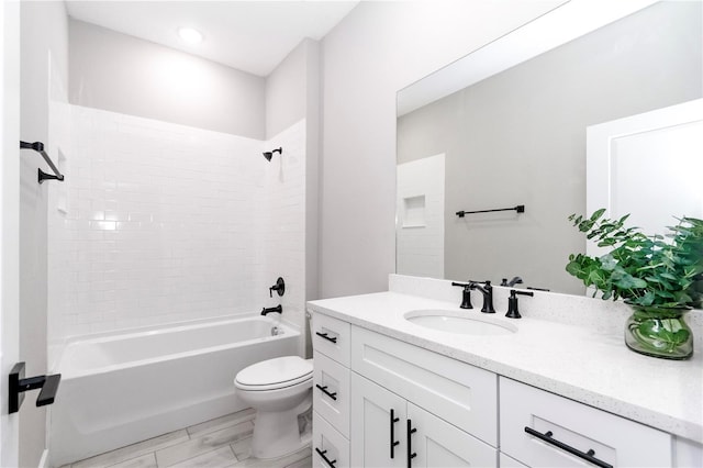 full bathroom with tiled shower / bath, hardwood / wood-style flooring, vanity, and toilet