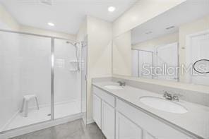 bathroom with vanity and walk in shower