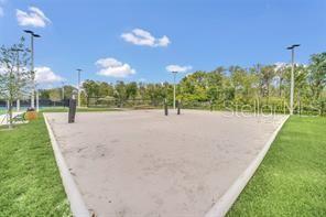 view of property's community featuring volleyball court and a yard