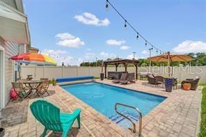 view of pool featuring a gazebo and a patio area