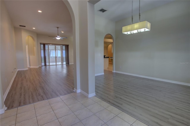 unfurnished room with ceiling fan and light tile patterned floors