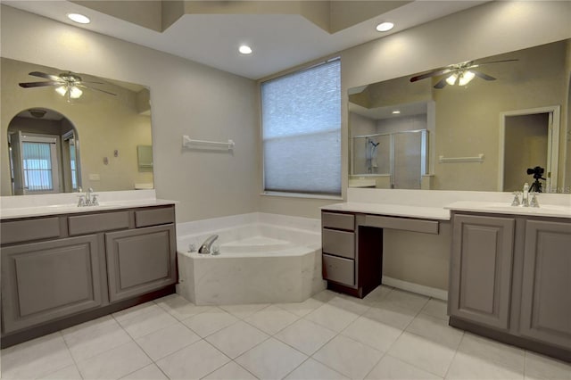 bathroom with tile patterned flooring, shower with separate bathtub, and vanity