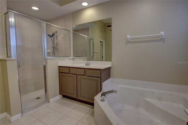 bathroom with tile patterned flooring, vanity, and shower with separate bathtub