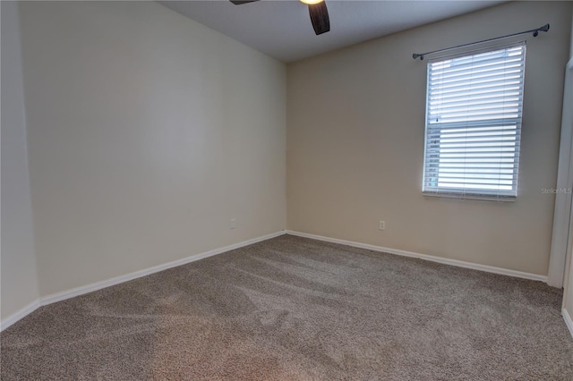 carpeted spare room with ceiling fan