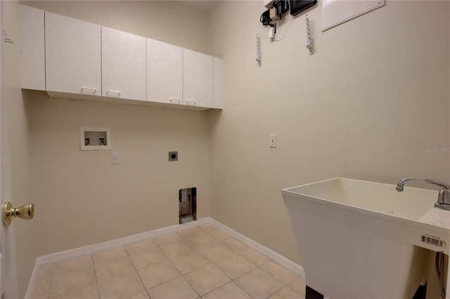 laundry area featuring cabinets, sink, washer hookup, light tile patterned floors, and hookup for an electric dryer