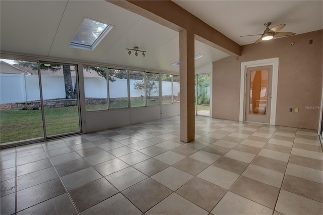 unfurnished sunroom with vaulted ceiling with skylight and ceiling fan