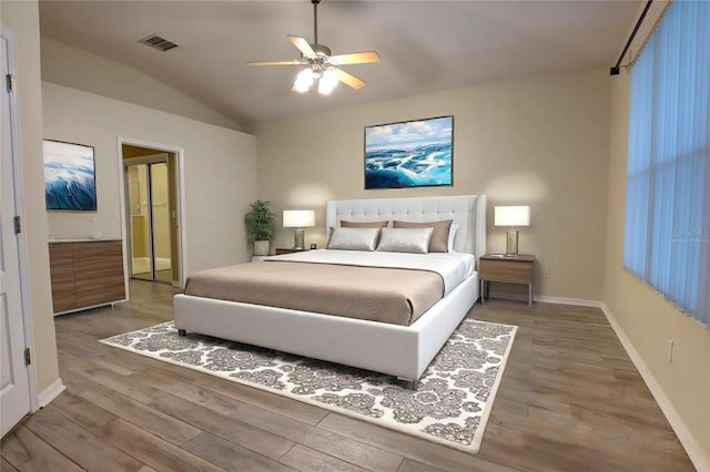 bedroom featuring hardwood / wood-style flooring, ceiling fan, and vaulted ceiling