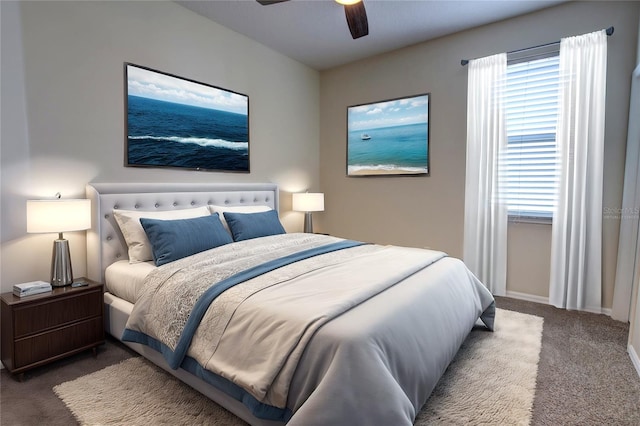 carpeted bedroom featuring ceiling fan and multiple windows