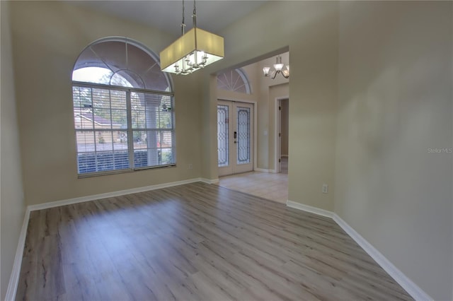 foyer featuring light hardwood / wood-style floors and a chandelier