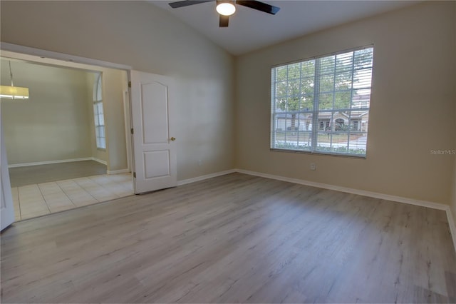 unfurnished room featuring light hardwood / wood-style floors, ceiling fan, and lofted ceiling