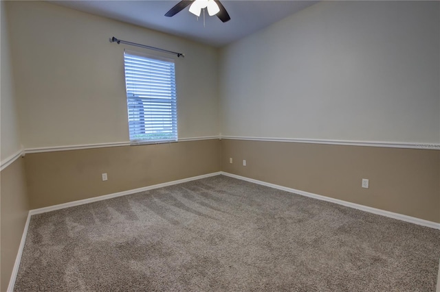 carpeted empty room featuring ceiling fan