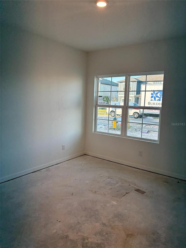 spare room featuring concrete flooring