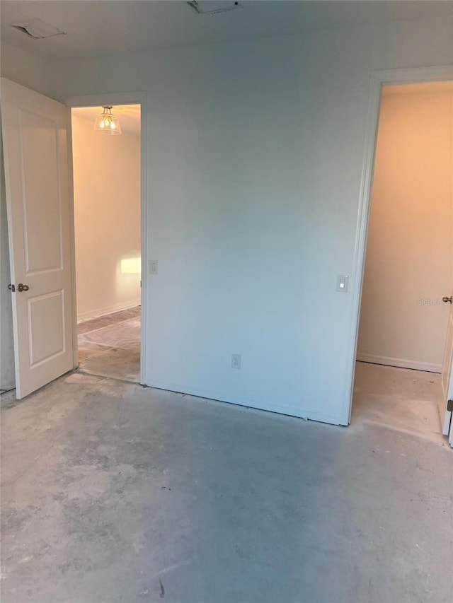 empty room featuring a chandelier