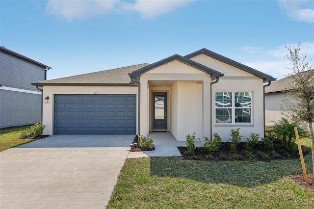 ranch-style house featuring a garage and a front lawn