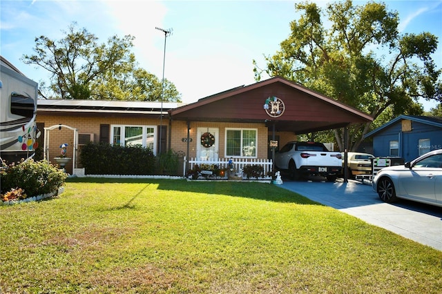 ranch-style house with a carport, solar panels, a porch, and a front yard