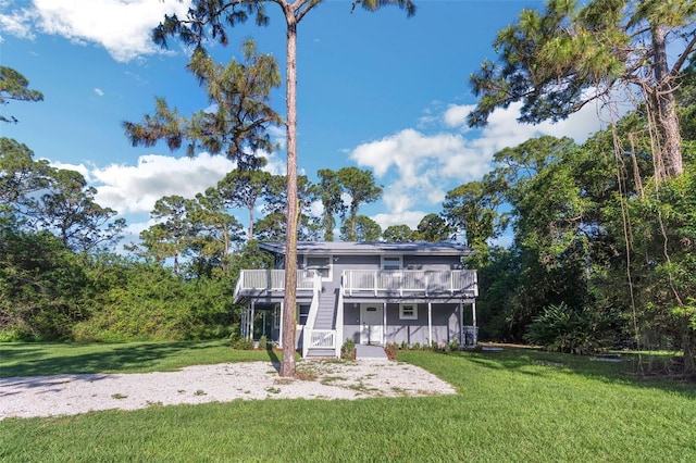 exterior space with a front yard and a wooden deck