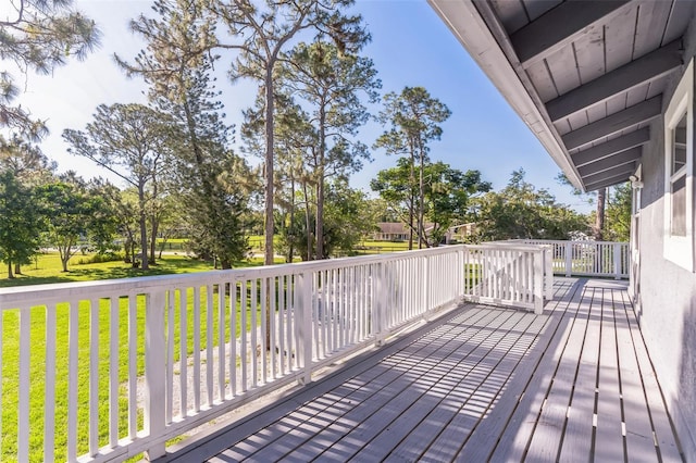 wooden deck with a lawn