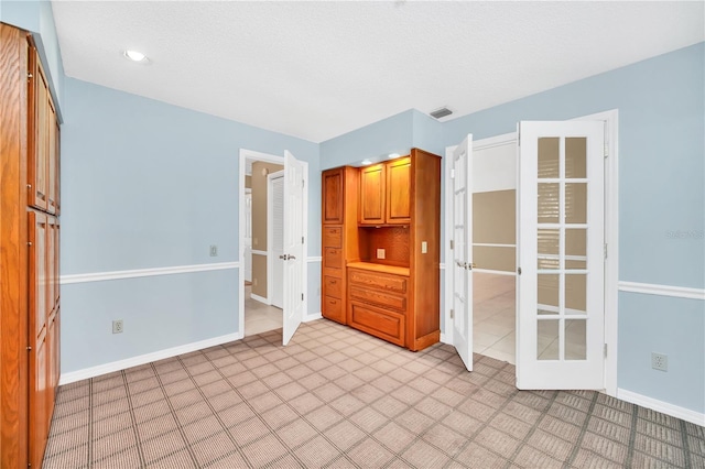 unfurnished room with a textured ceiling