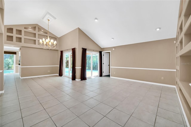 spare room with a wealth of natural light, light tile patterned floors, and high vaulted ceiling