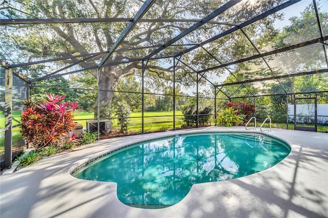 view of swimming pool featuring a lanai and a patio area