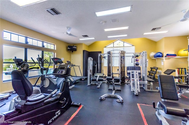 exercise room with a textured ceiling and ceiling fan