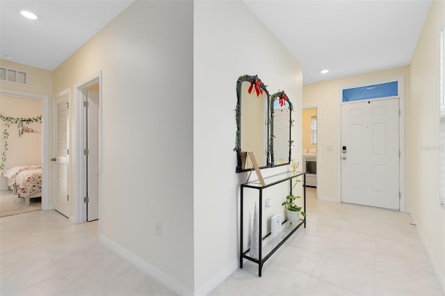 corridor featuring light tile patterned floors